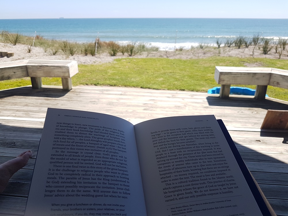 Someone reading a book outside